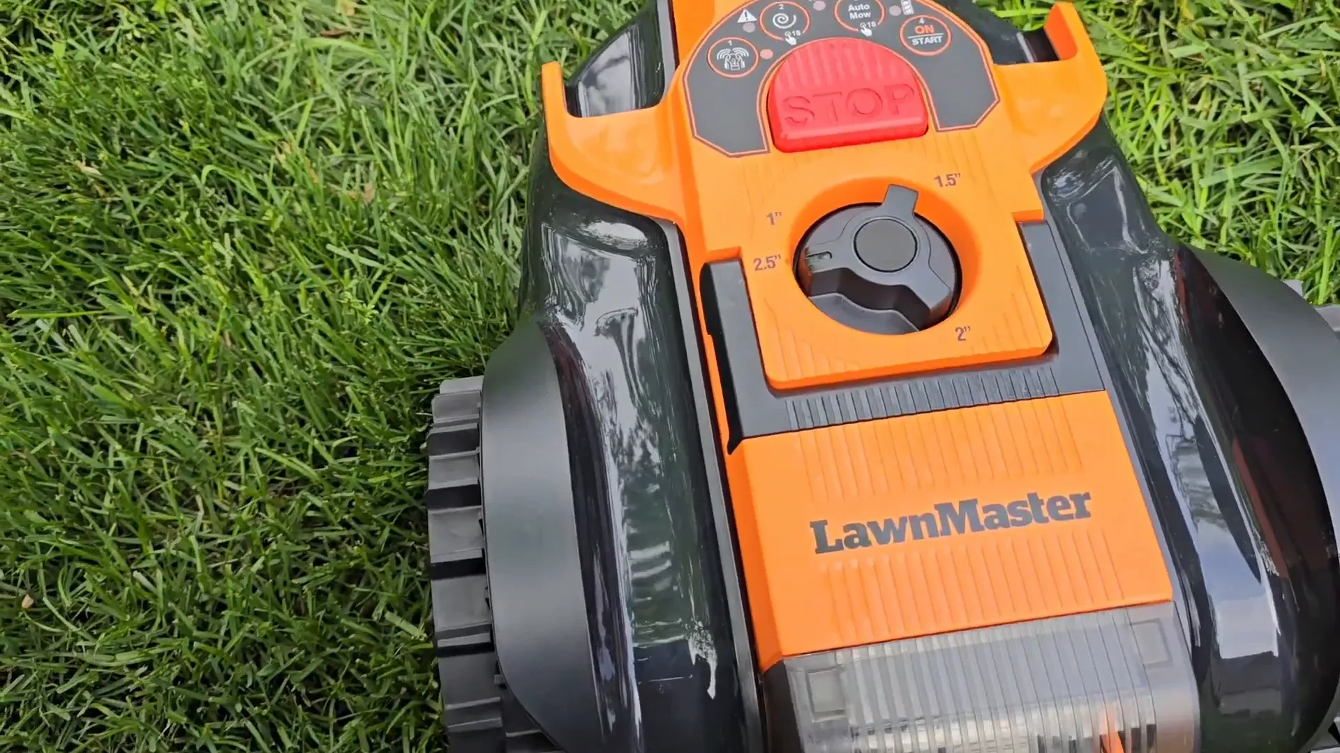 LawnMaster robot mower showing carrying handle and top controls