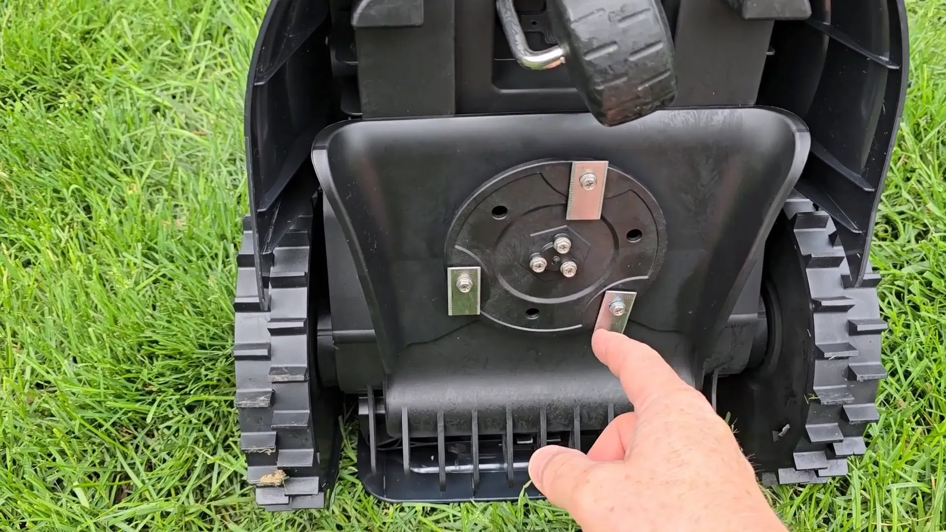 LawnMaster robot mower showing carrying handle and top controls