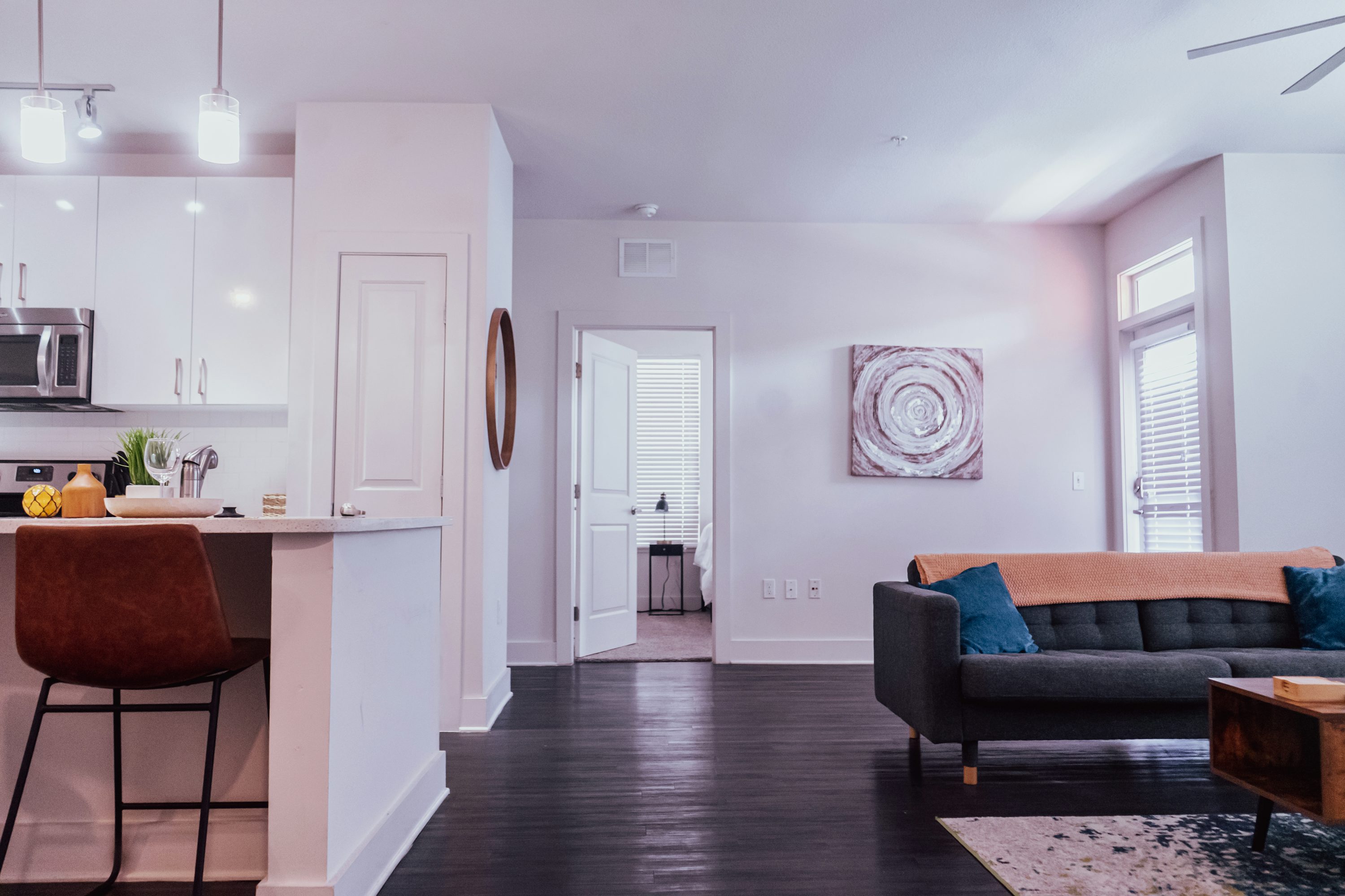 a living room filled with furniture and a kitchen